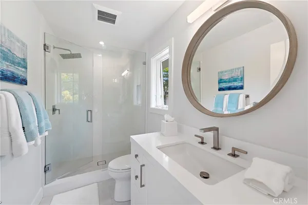 an aerial view of residential houses with outdoor space and parking