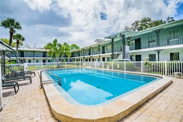 a view of a house with a yard and potted plants