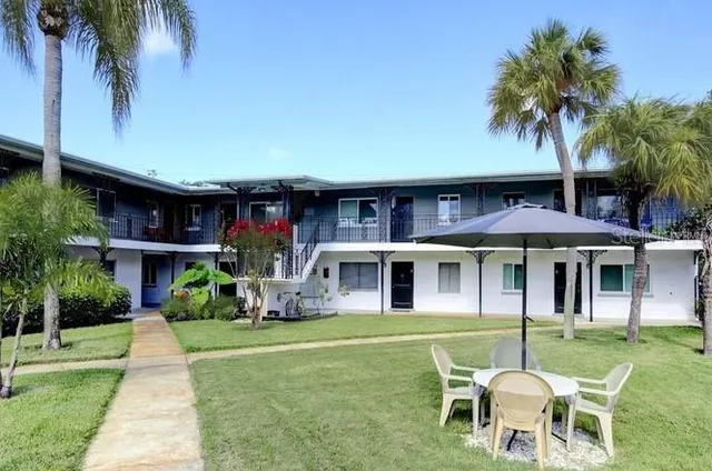 a view of a house with swimming pool and sitting area