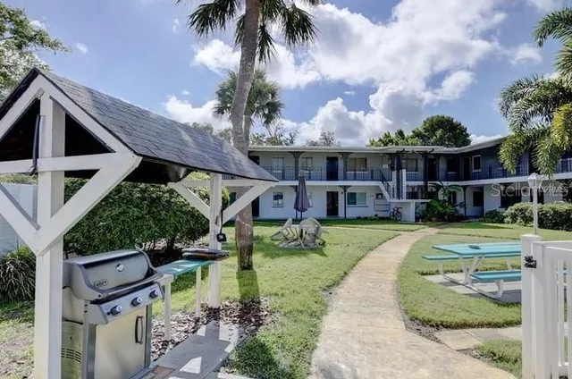 a view of a balcony with a floor to ceiling window and wooden fence