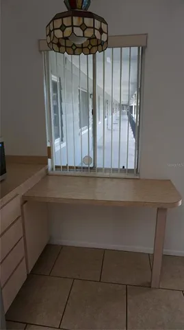 a kitchen with a sink a refrigerator and cabinets