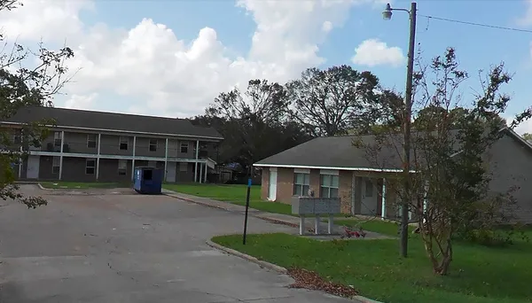 a view of house with a yard