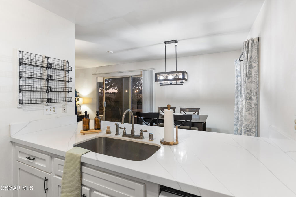 2324 Miramar Walk Oxnard, CA 93035 - Photo 7 of 24 a kitchen with a sink a center island and stainless steel appliances