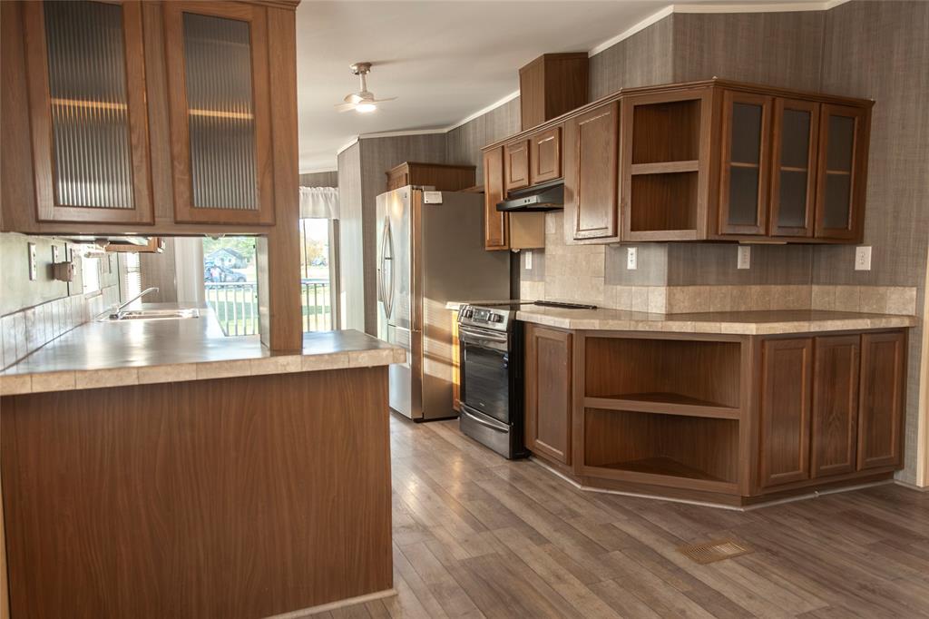 112 Southeast Front Street Bailey, TX 75452 - Photo 10 of 38 a kitchen with stainless steel appliances granite countertop a stove and a sink