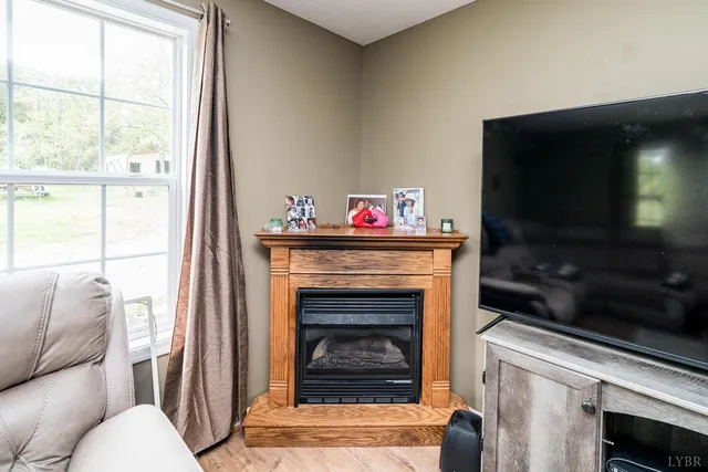 a kitchen with stainless steel appliances granite countertop a sink dishwasher a stove a microwave oven and a dining table with wooden floor