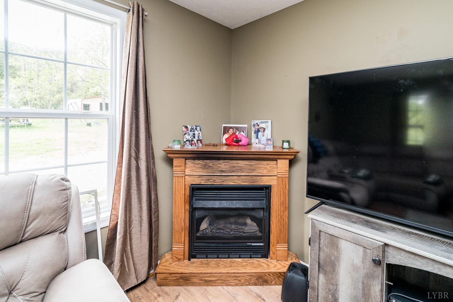 360 Theta Mill Road Gladys, VA 24554 - Photo 11 of 25 a living room with furniture and a fireplace