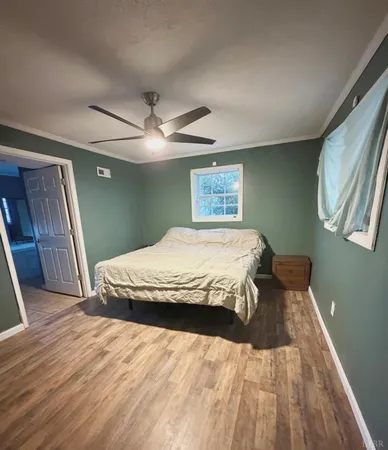 a kitchen with stainless steel appliances granite countertop a sink dishwasher a stove a microwave oven and a dining table with wooden floor