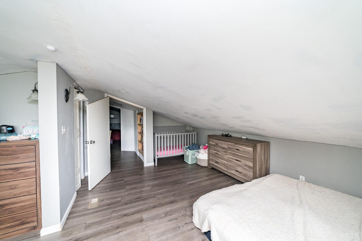 360 Theta Mill Road Gladys, VA 24554 - Photo 22 of 30 a bedroom with a bed and wooden floor