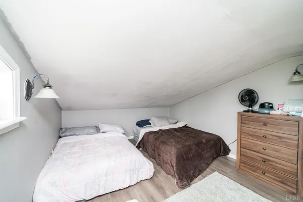 a bedroom with furniture and a window