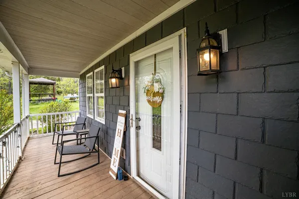 a building outdoor space with patio furniture and wooden floor