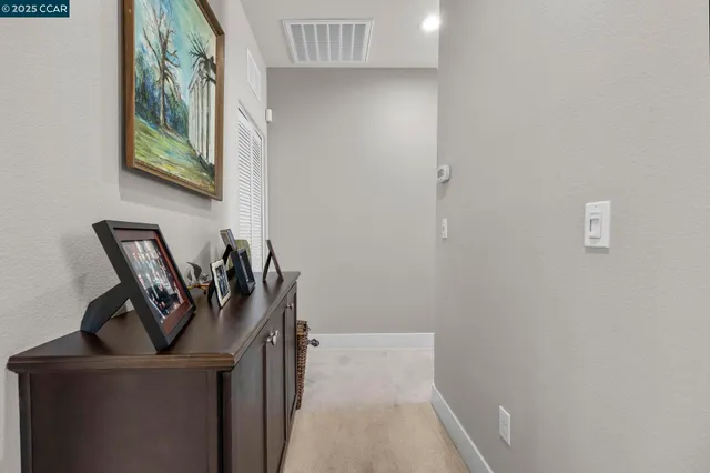 a view of a hallway with seating area