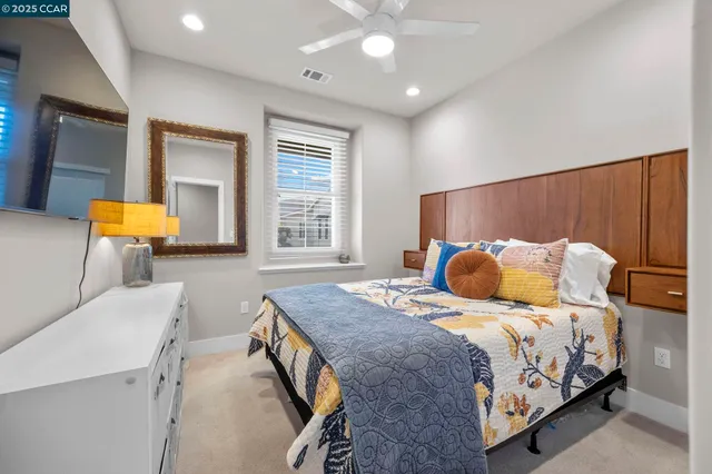 a bedroom with a large bed and a chandelier