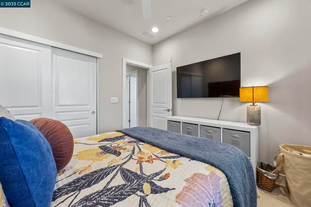 a bedroom with a bed and a flat screen tv