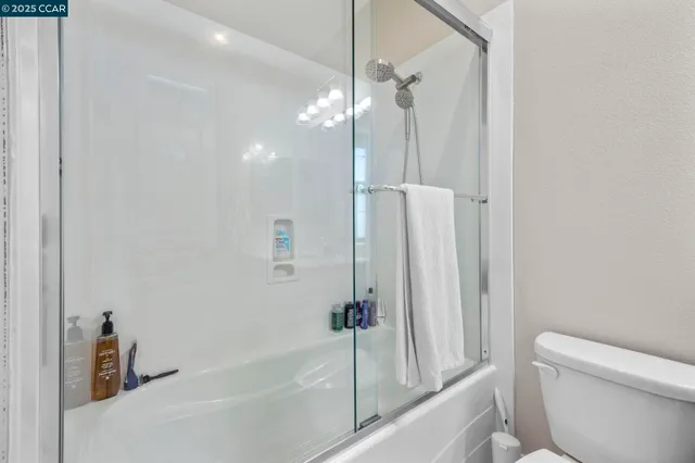 a bathroom with a shower a toilet and a sink