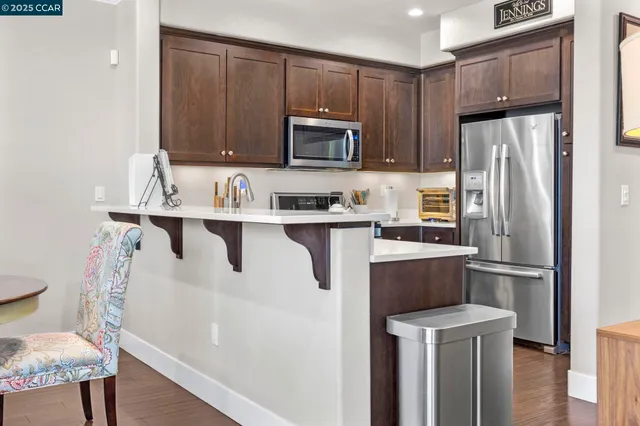 a kitchen with stainless steel appliances a refrigerator stove microwave and sink