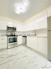 a kitchen with cabinets and steel stainless steel appliances