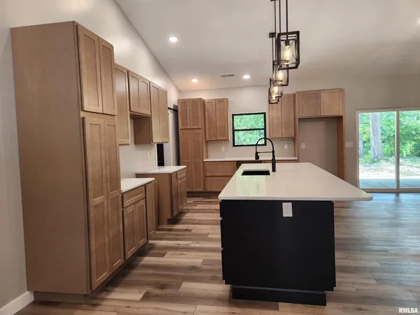 an empty room with wooden floor and closet