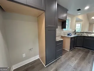 a kitchen with cabinets and stainless steel appliances