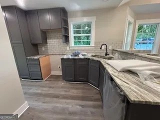 a kitchen with a sink stove and cabinets