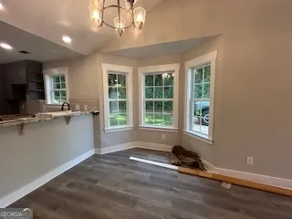 a view of room with a window and wooden floor
