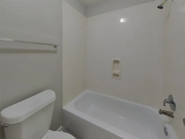 a bathroom with a toilet and bathtub