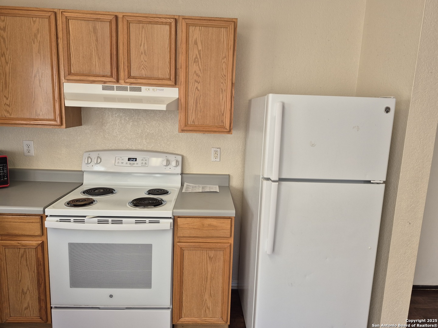 102 Kenrock Ridge San Antonio, TX 78254 - Photo 11 of 30 a kitchen with refrigerator a stove a washer and dryer