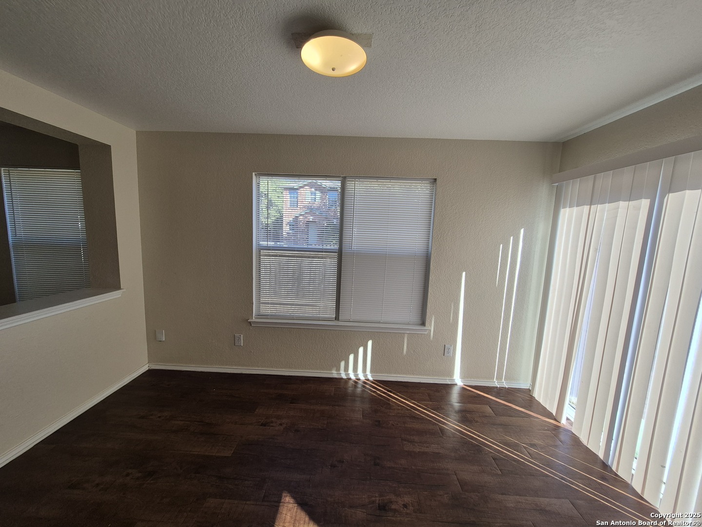 102 Kenrock Ridge San Antonio, TX 78254 - Photo 12 of 30 an empty room with wooden floor and windows