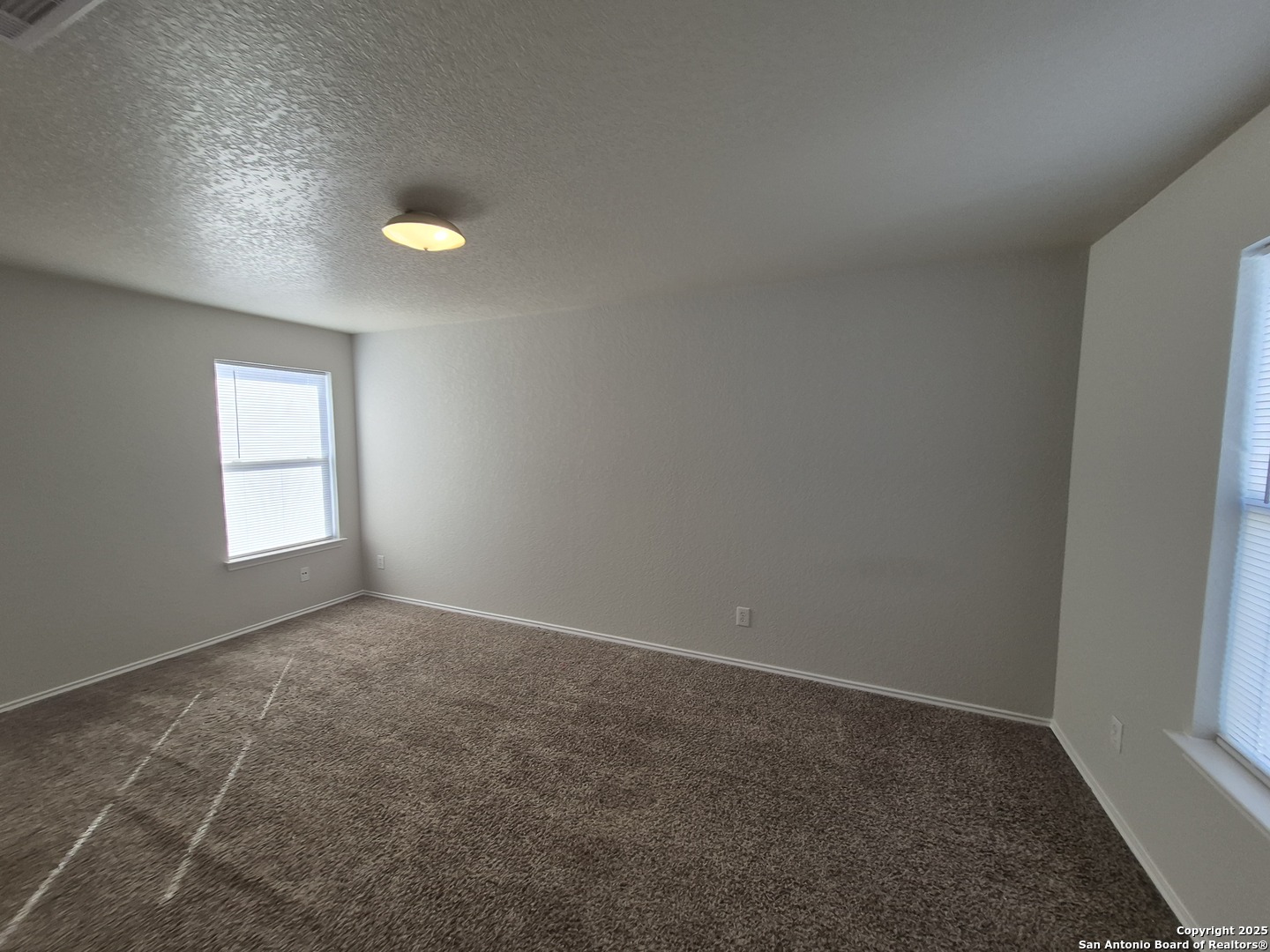 102 Kenrock Ridge San Antonio, TX 78254 - Photo 15 of 30 an empty room with windows and closet