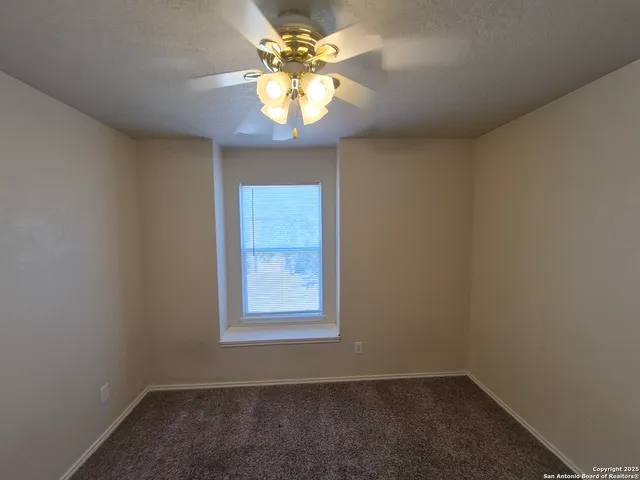 an empty room with closet and windows