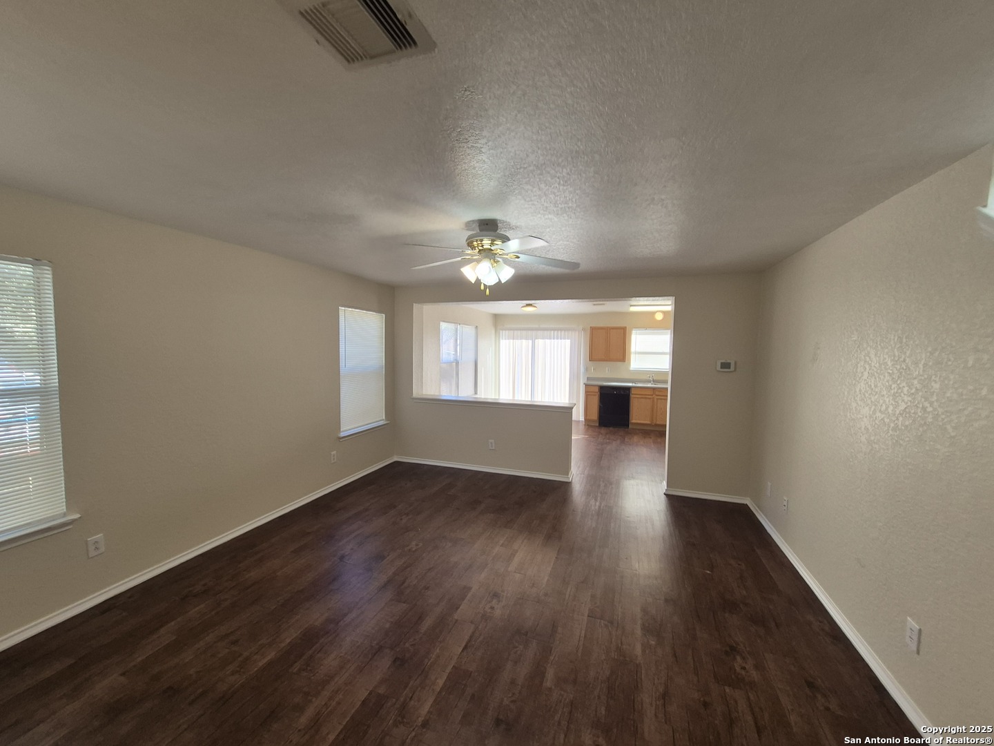 102 Kenrock Ridge San Antonio, TX 78254 - Photo 3 of 30 an empty room with wooden floor chandelier and windows