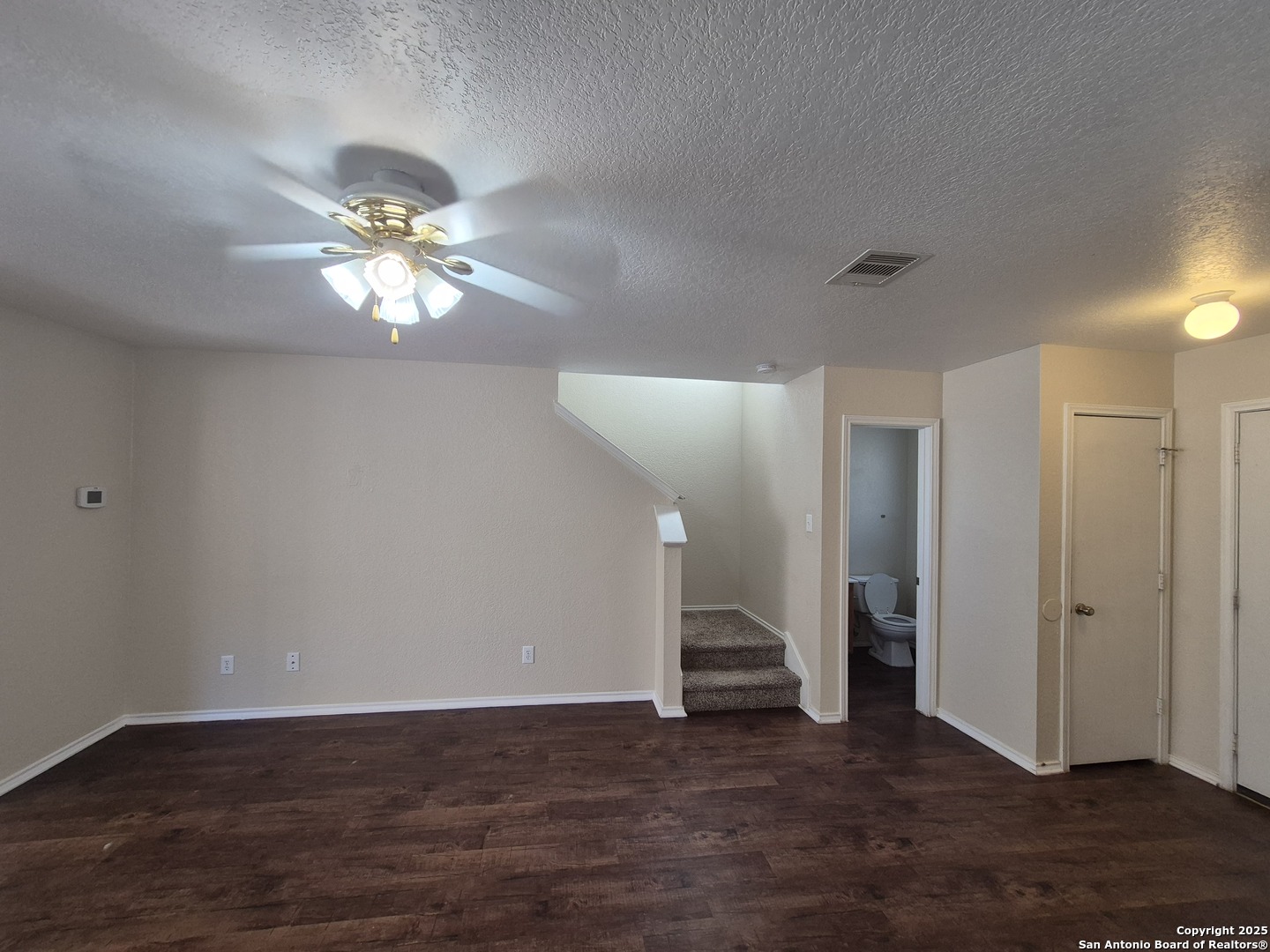 102 Kenrock Ridge San Antonio, TX 78254 - Photo 5 of 30 an empty room with wooden floor and ceiling fan
