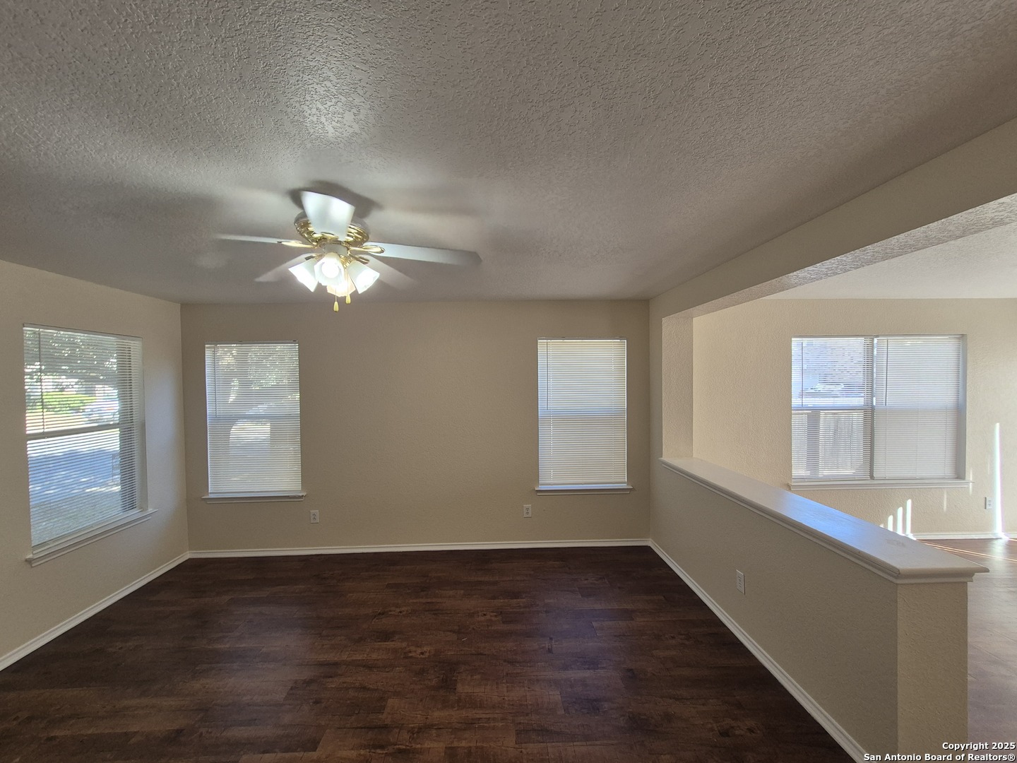102 Kenrock Ridge San Antonio, TX 78254 - Photo 7 of 30 a view of an empty room with a window and wooden floor
