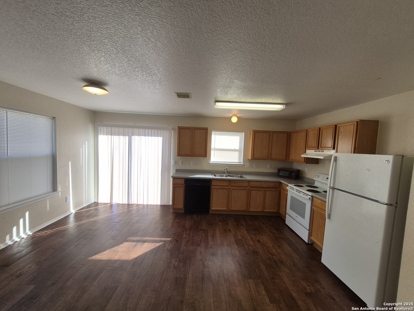 102 Kenrock Ridge San Antonio, TX 78254 - Photo 8 of 30 a kitchen with a refrigerator and a stove top oven