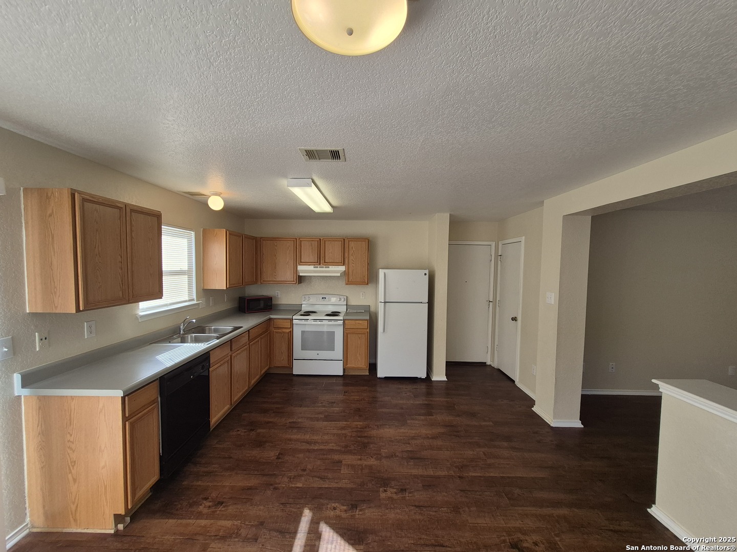 102 Kenrock Ridge San Antonio, TX 78254 - Photo 9 of 30 a kitchen with stainless steel appliances granite countertop a stove a sink dishwasher and a refrigerator with wooden floor