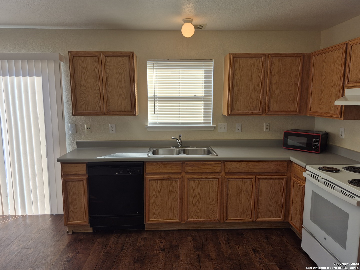 102 Kenrock Ridge San Antonio, TX 78254 - Photo 10 of 30 a kitchen with stainless steel appliances granite countertop wooden cabinets a sink a stove a dining table and chairs