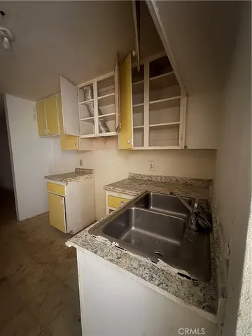 a kitchen that has a sink and a stove