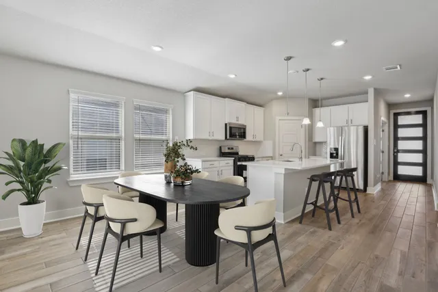 a view of a dining room with furniture and wooden floor