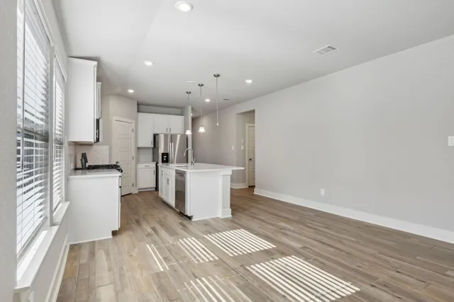 a view of kitchen with furniture and wooden floor