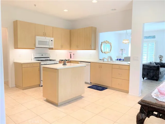 a kitchen with a sink a stove top oven cabinets and a counter top space