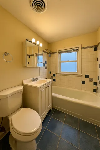 a bathroom with a sink a toilet and bathtub