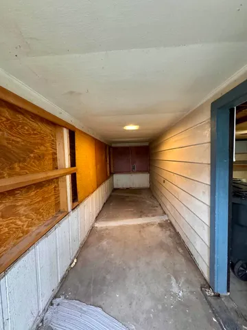 a front view of a house with a garden and trees