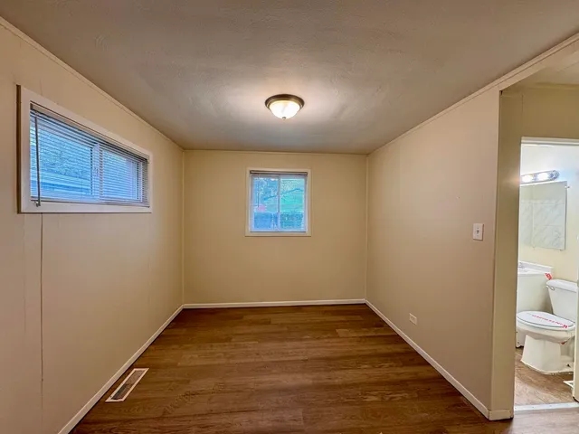 a view of a room with wooden floor and window