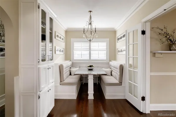 a spacious bedroom with a bed and a chandelier