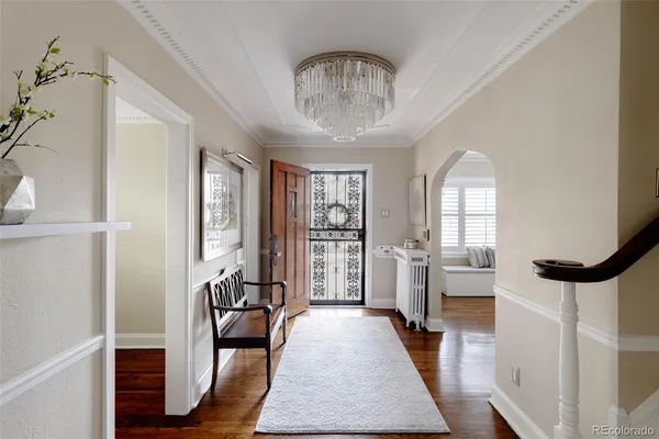 a very nice looking room with wooden floor and furniture