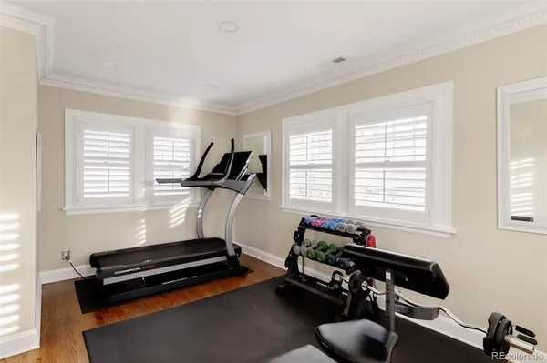 a room with furniture gym equipment and a window