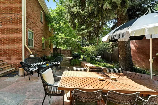 a view of a patio with table and chairs and potted plants