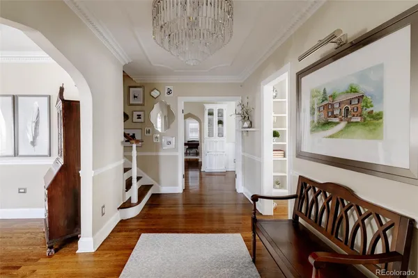 a view of a hallway with wooden floor and stairs