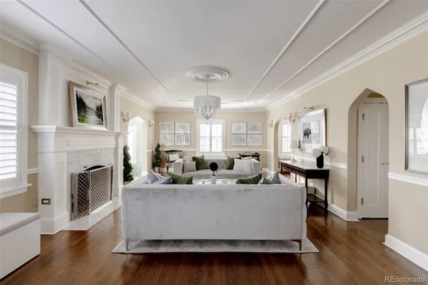 a living room with fireplace furniture and a wooden floor