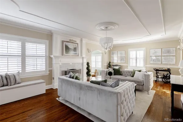 a living room with fireplace furniture and a large window
