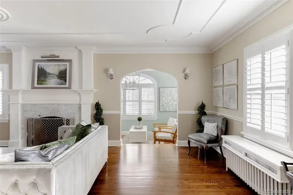a living room with furniture fireplace and a large window